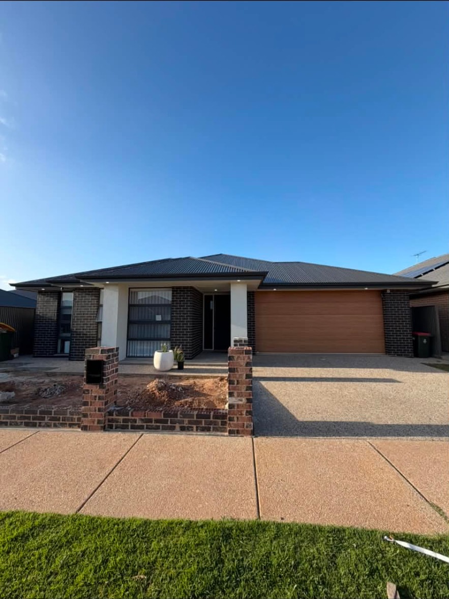 New home frontage with soffit lighting and garage power completed